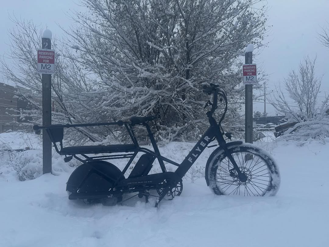 A Flyer cargo bike parked in fresh snow