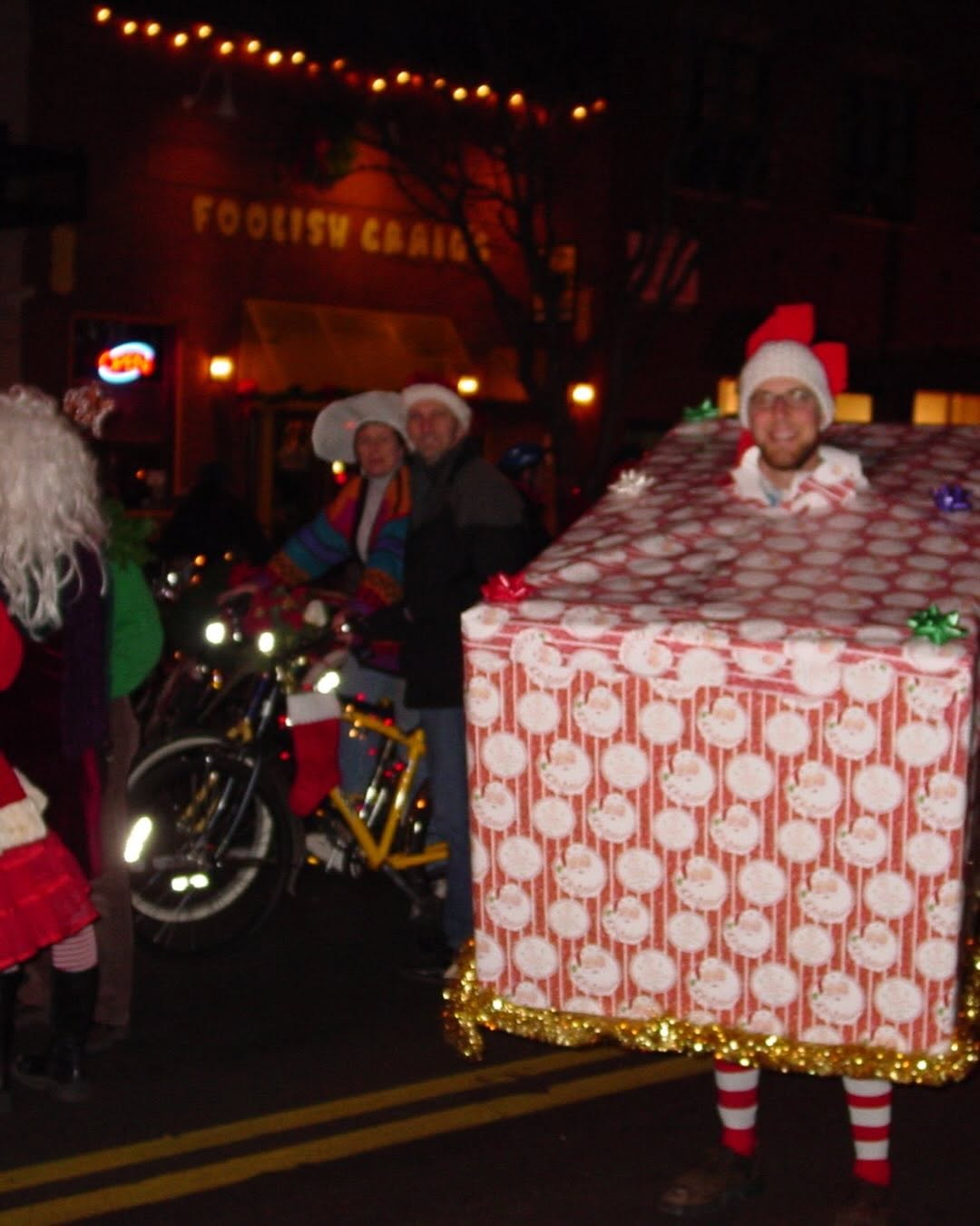 Cargo-bike riders in a nighttime holiday parade